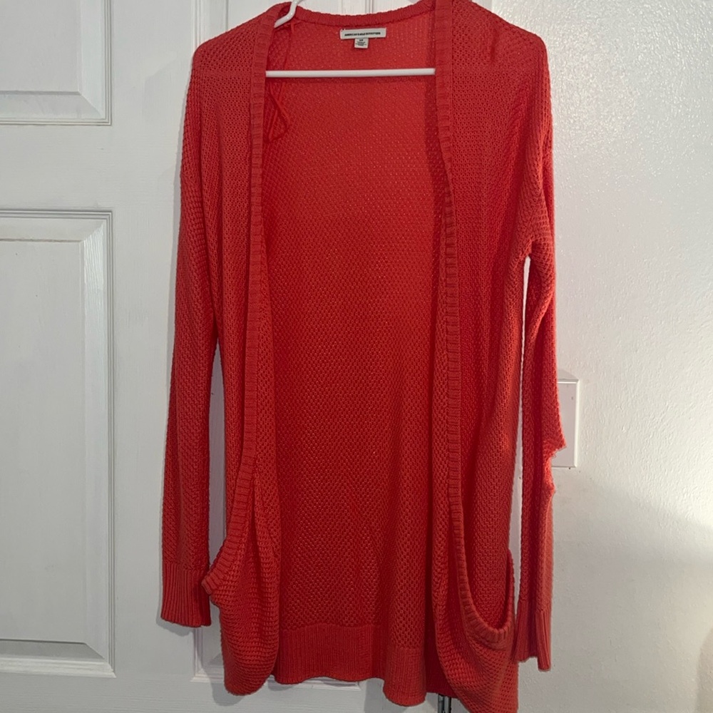 Sweater cardigan. Hole in left sleeve.